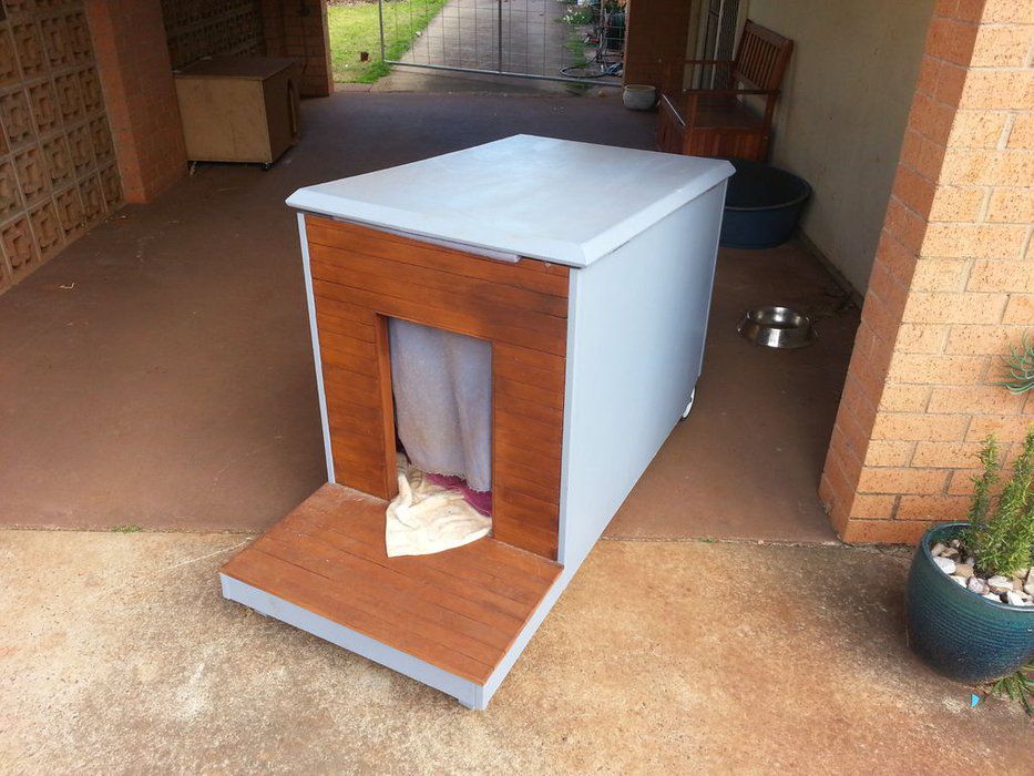 A blue and brown mobile dog house