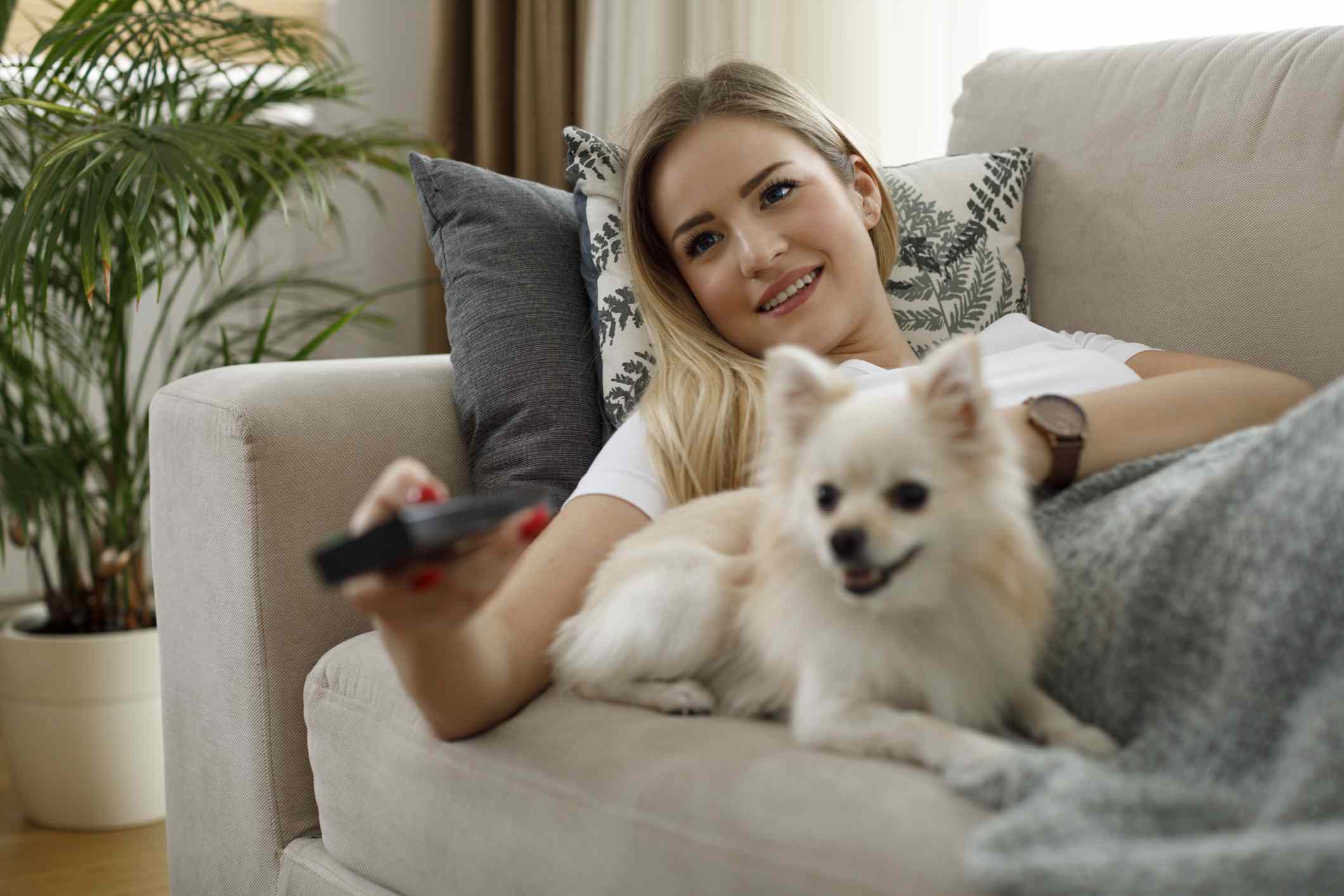 woman watching tv with her dog