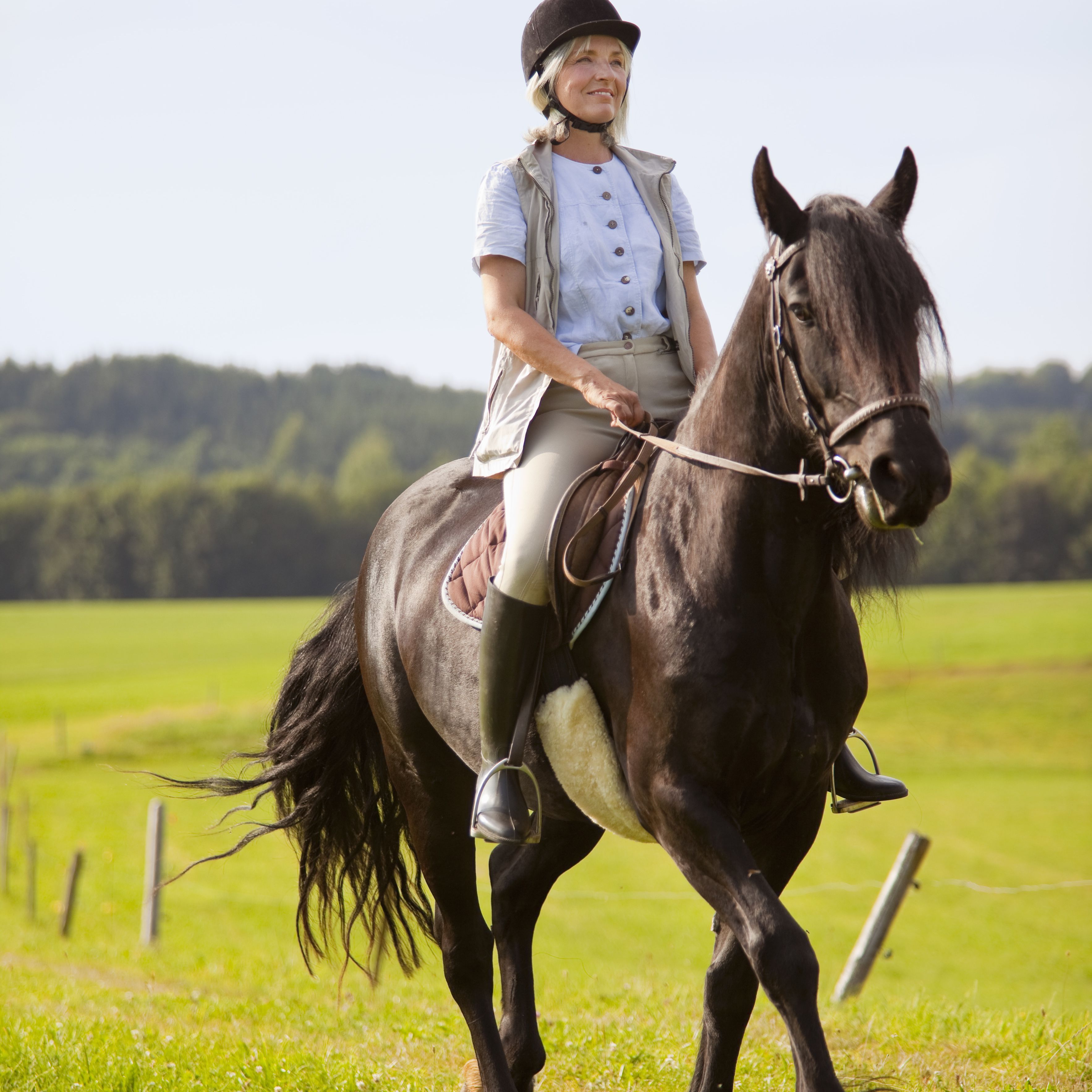 Germany, Bavaria, Mature woman riding horse